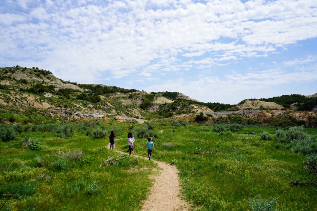 My kids hiking the Coal Vein Nature Trail in Theodore Roosevelt National Park itinerary 