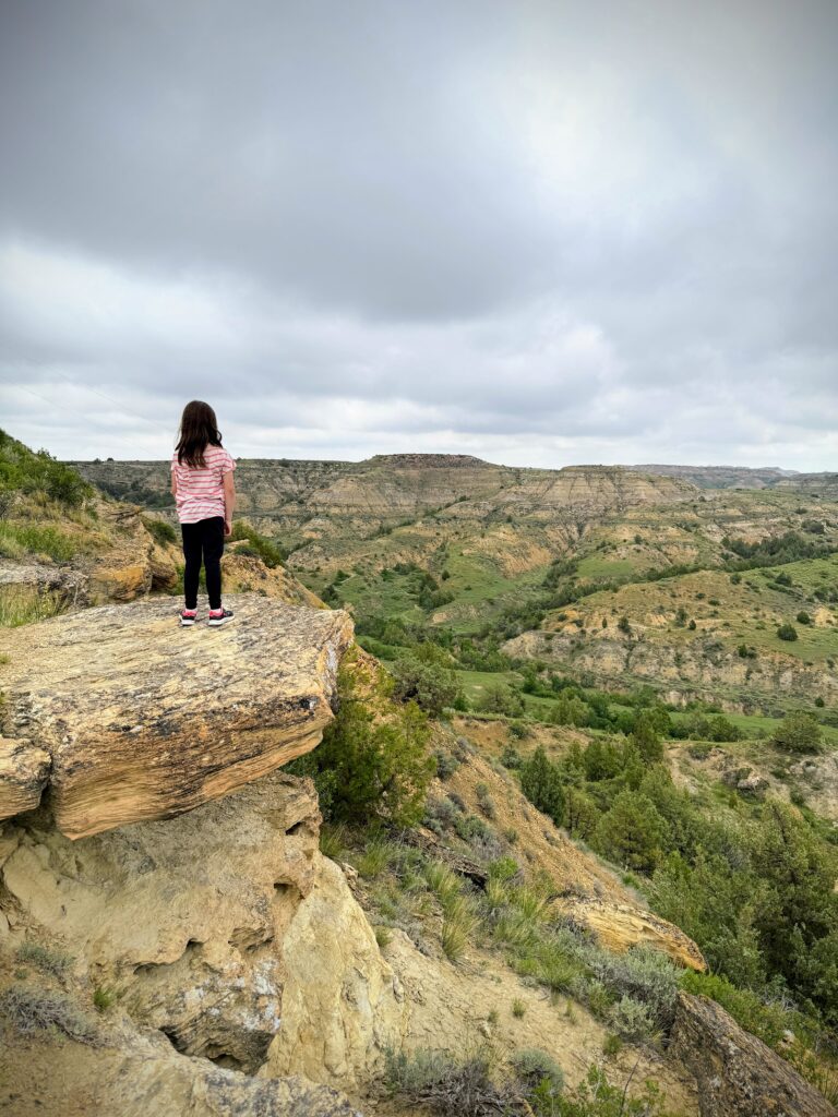 Girl hiking the point-to-point trails in Medora, North Dakota
