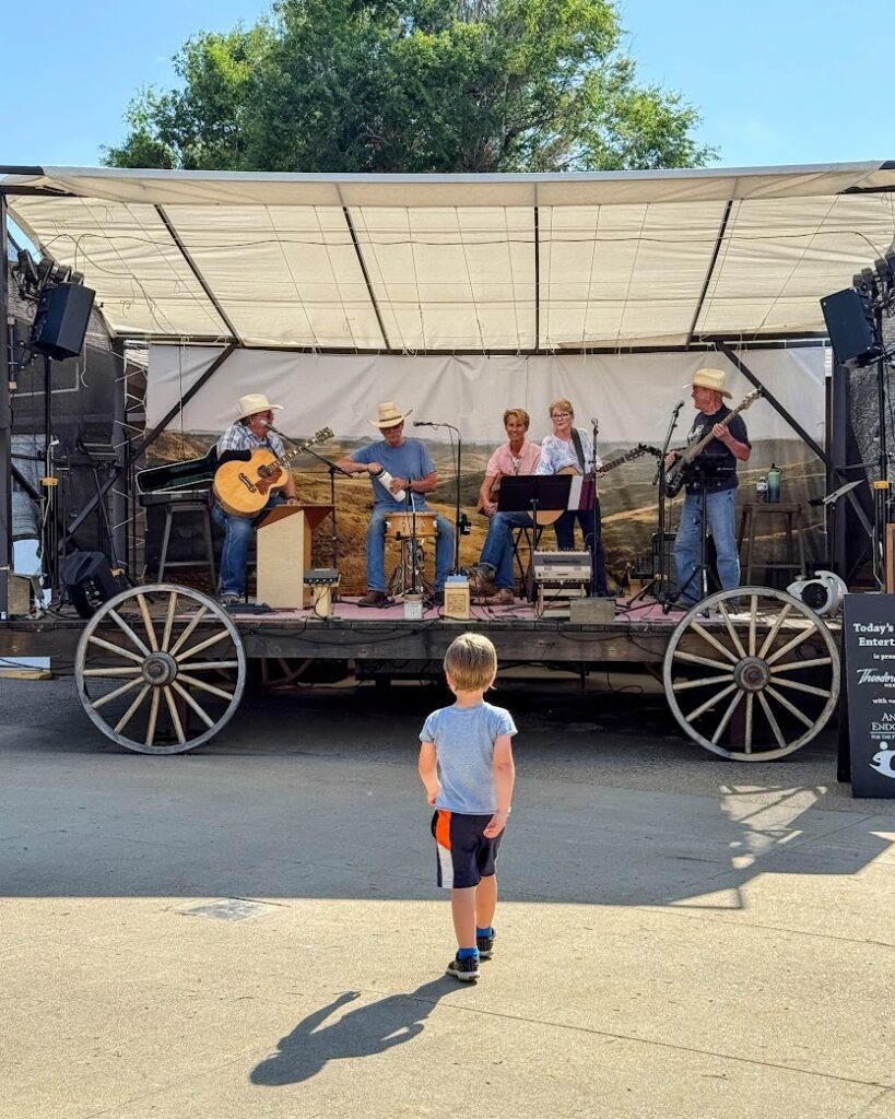 A folk band playing at Town Square Patio in downtown, Medora