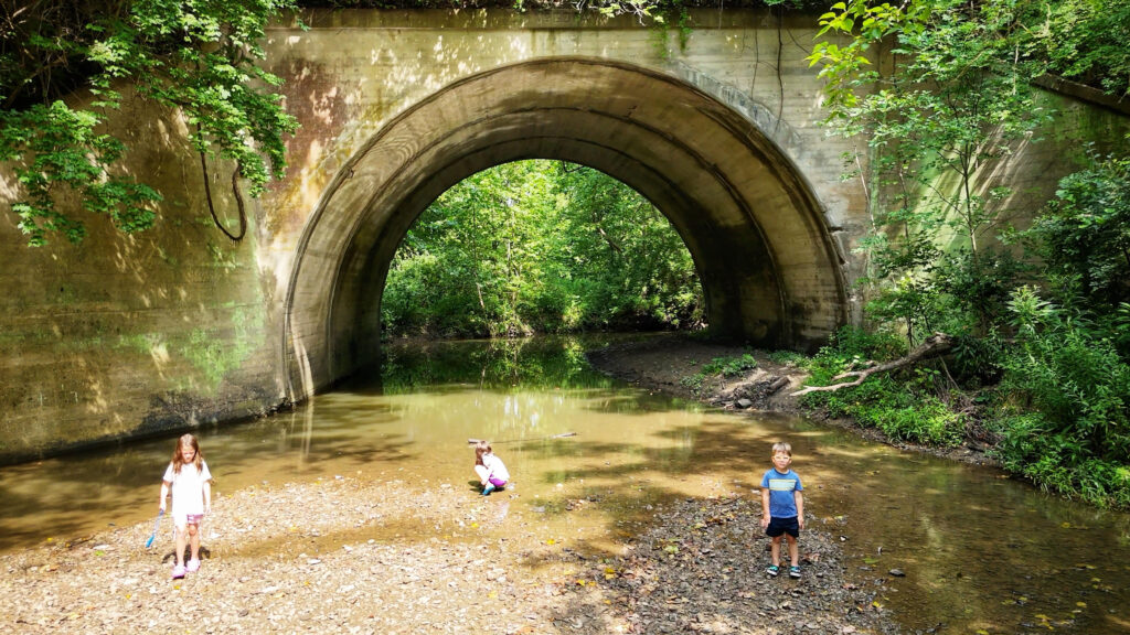Shallow creek exploration at a Liberty park.
