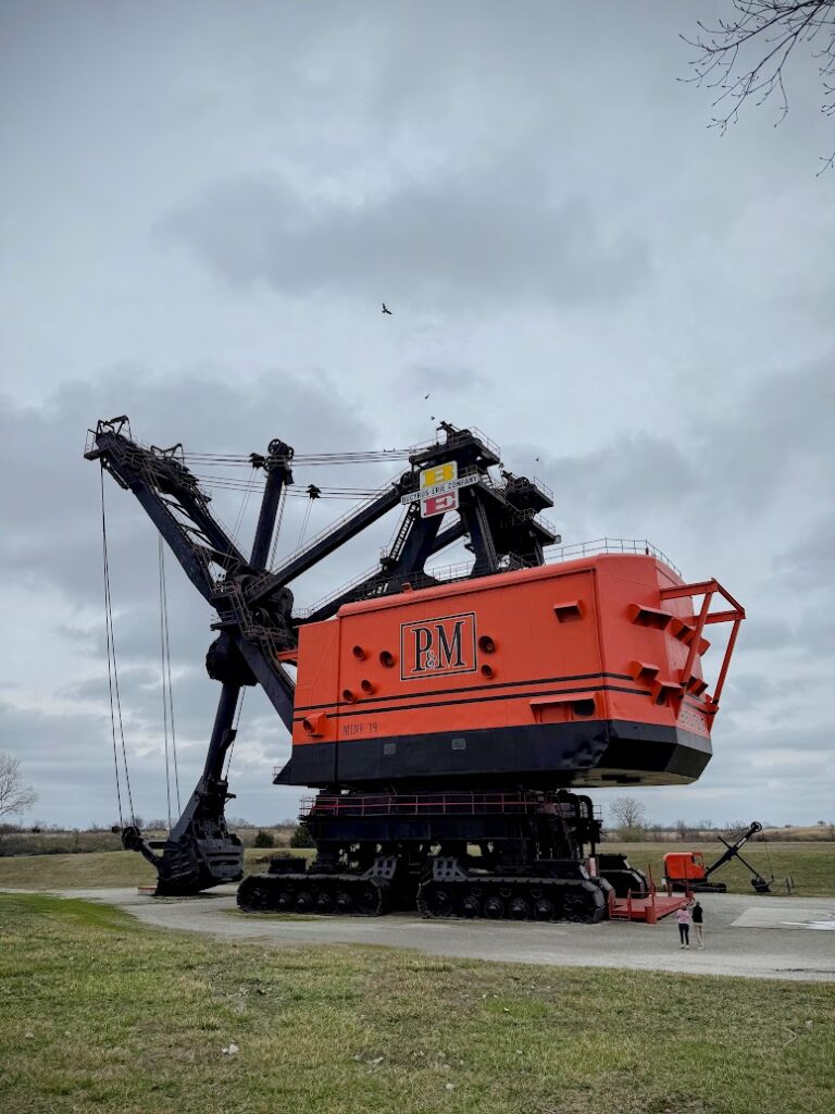 Big Brutus, the world's largest electric shovel, with two people in the foreground to show scale 