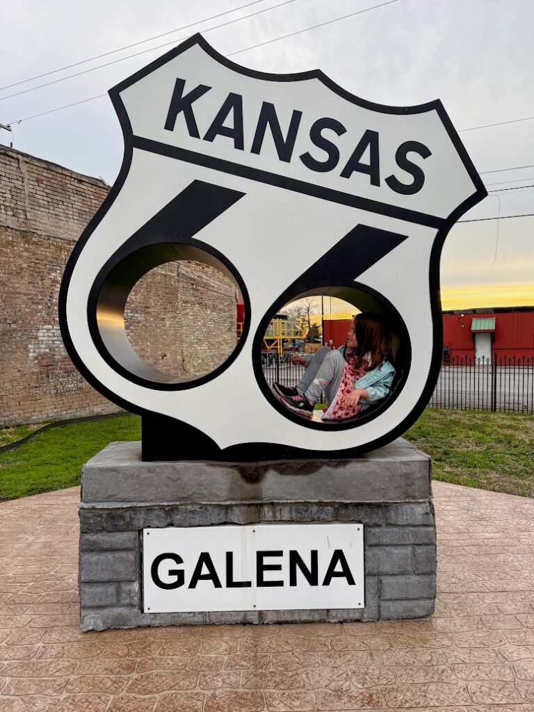 My daughter in a large Route 66 shield in Galena, Kansas 
