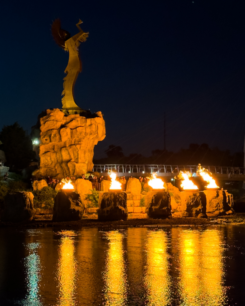 Children watch the iconic Ring of Fire illuminate the night sky along the Arkansas River in Wichita, Kansas.